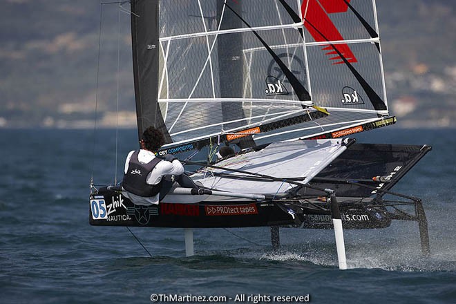 12_17726  ©Th.Martinez/Sea&Co.  CAMPIONE DEL GARDA - ITALY . 23 August  2012 . <br />
2012 ZHIK NAUTICA MOTH WORLDS. Day 5.<br />
05-Bora Gulari(USA5), 03-Scott Babbage(AUS3) © Th Martinez.com http://www.thmartinez.com
